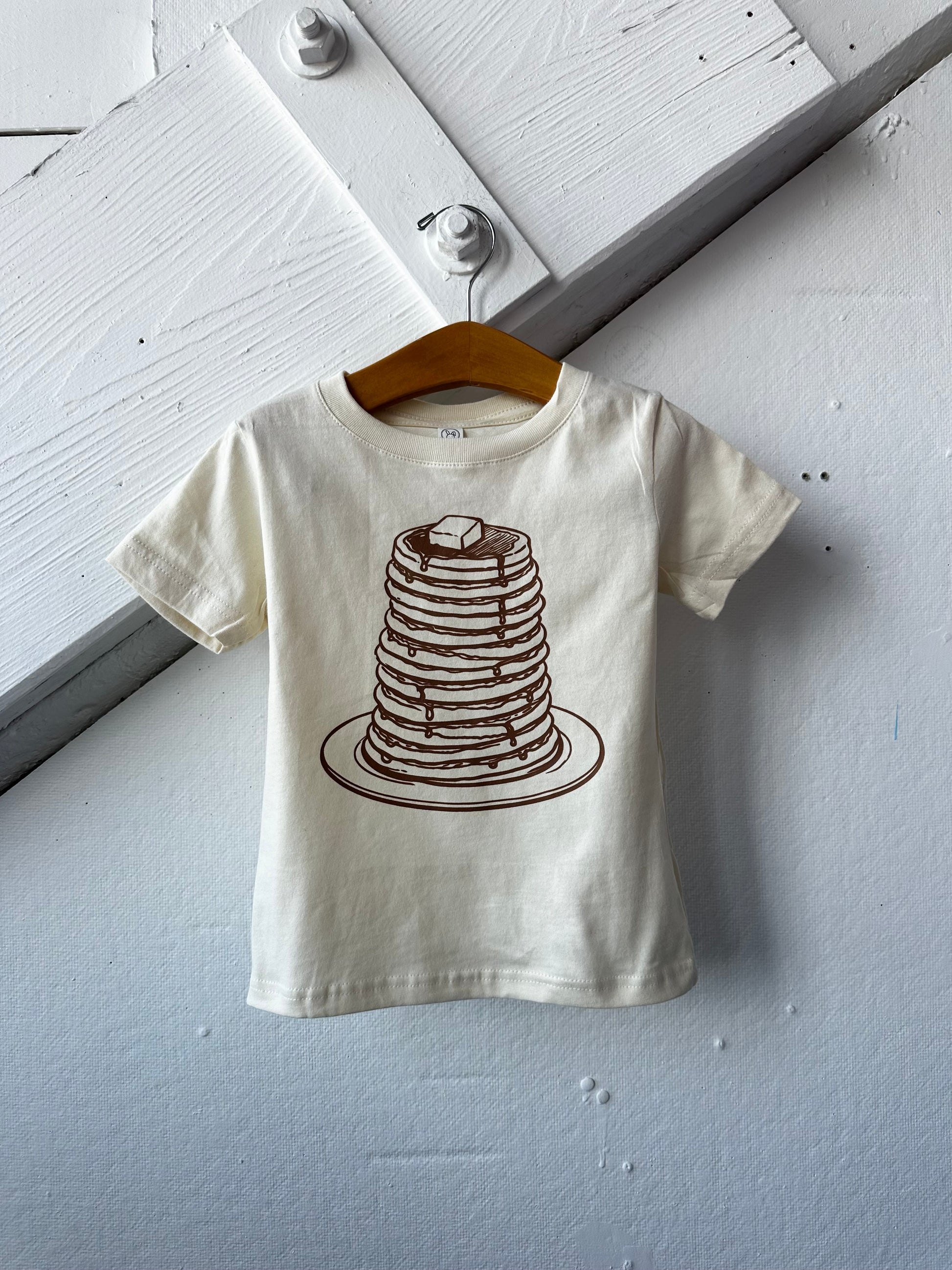 Kids graphic T-shirt featuring a playful pancake design from The Wishing Elephant, perfect for kids' casual wear.