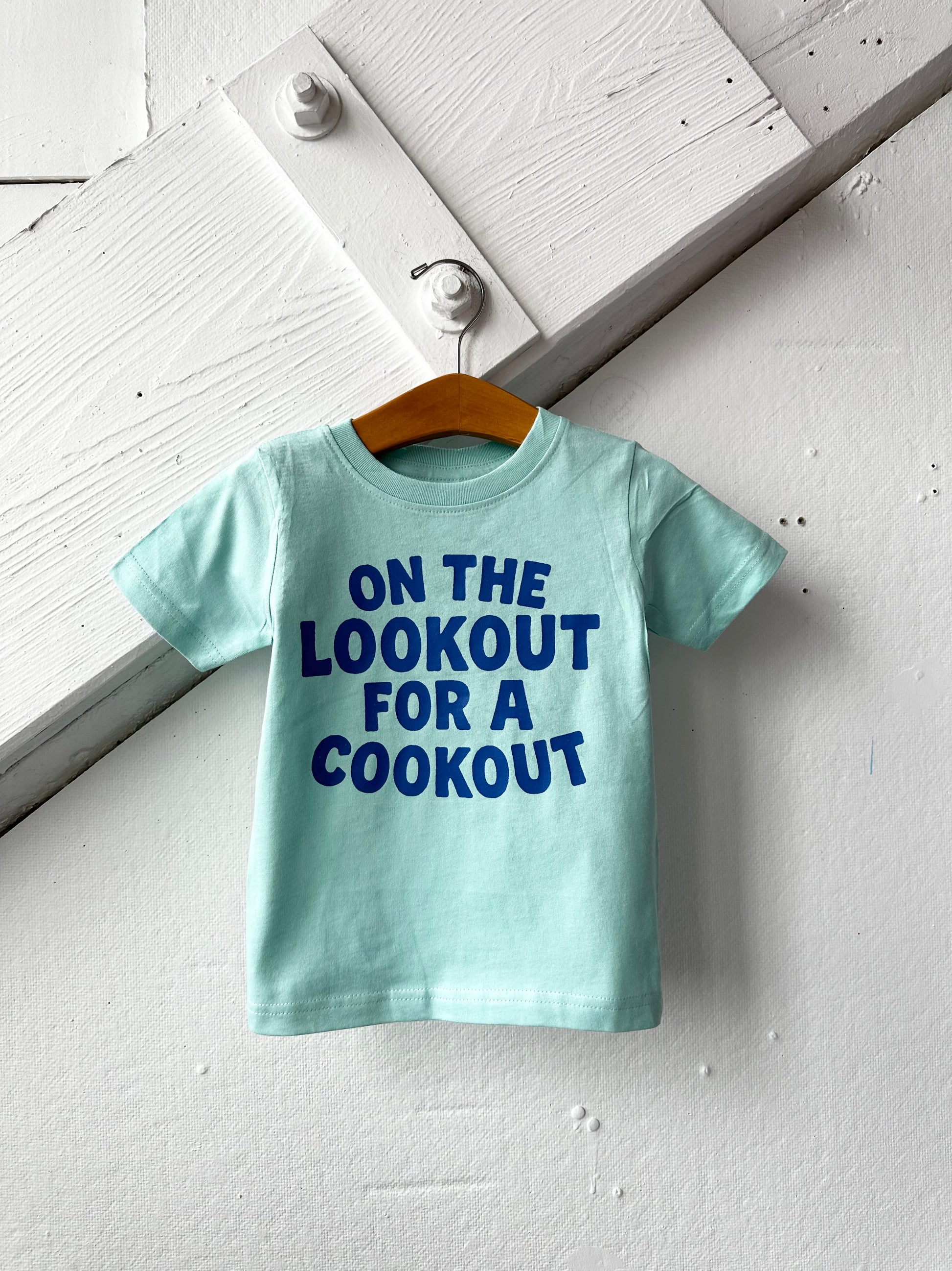 Kids graphic T-shirt by The Wishing Elephant featuring a mint green cookout and BBQ design, perfect for summer boys and girls.