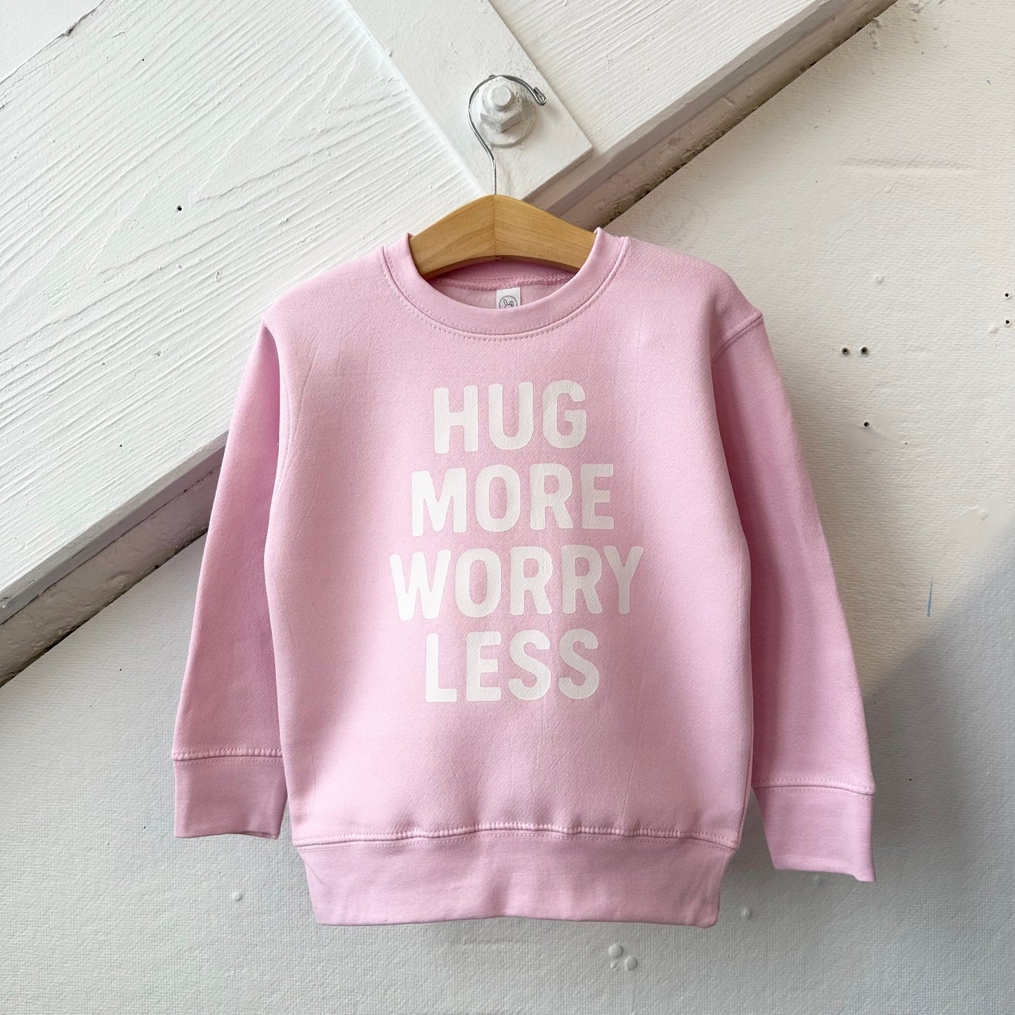 Hug More Worry Less motivational quote print by The Wishing Elephant featuring comforting handwritten lettering on white background