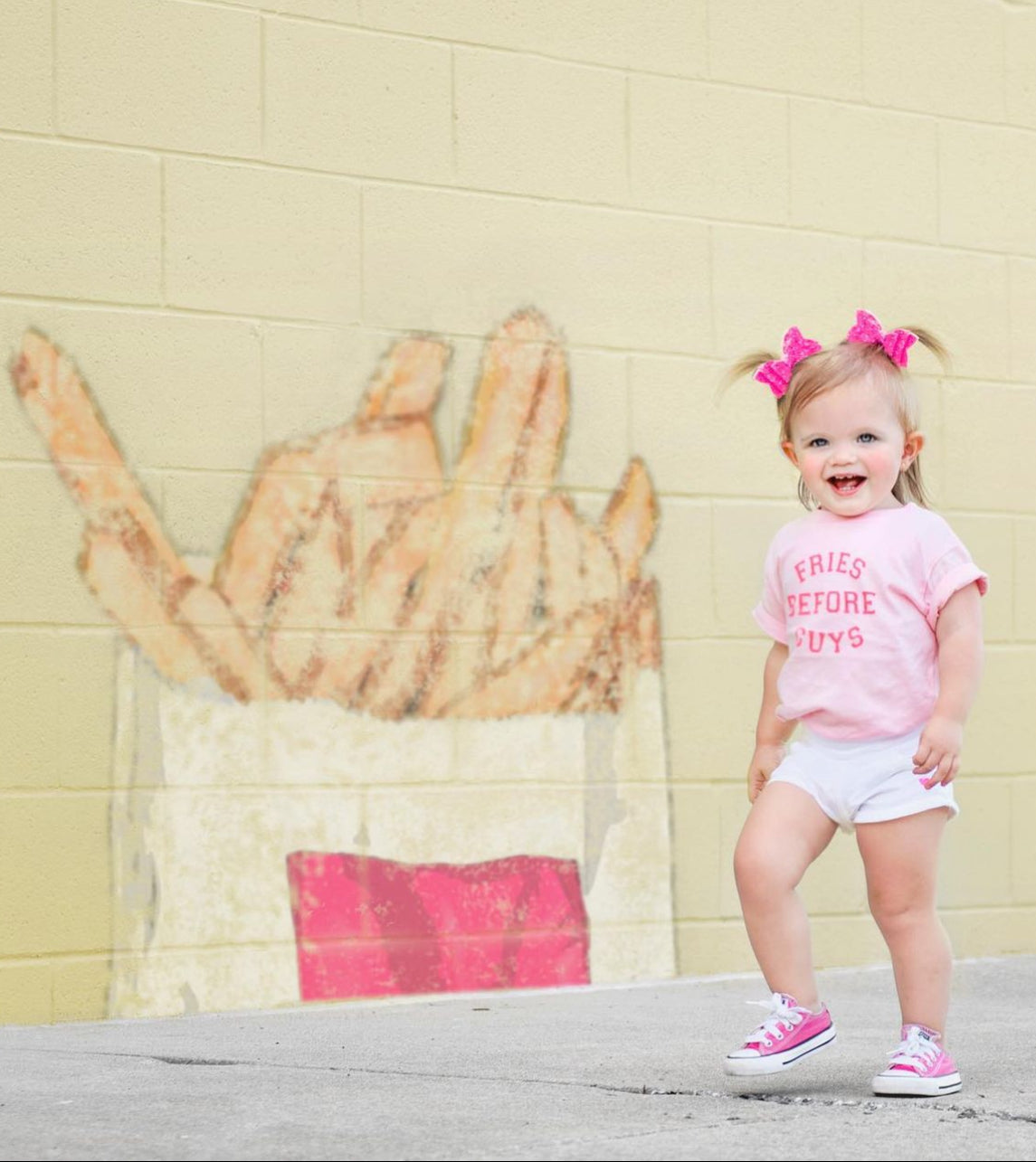 Fries Before Guys shirt flat lay with pink background

Funny retro t-shirt for toddlers – fries before guys design

Girl wearing Fries Before Guys tee in backyard

Sassy pink kids’ shirt with retro camp vibes