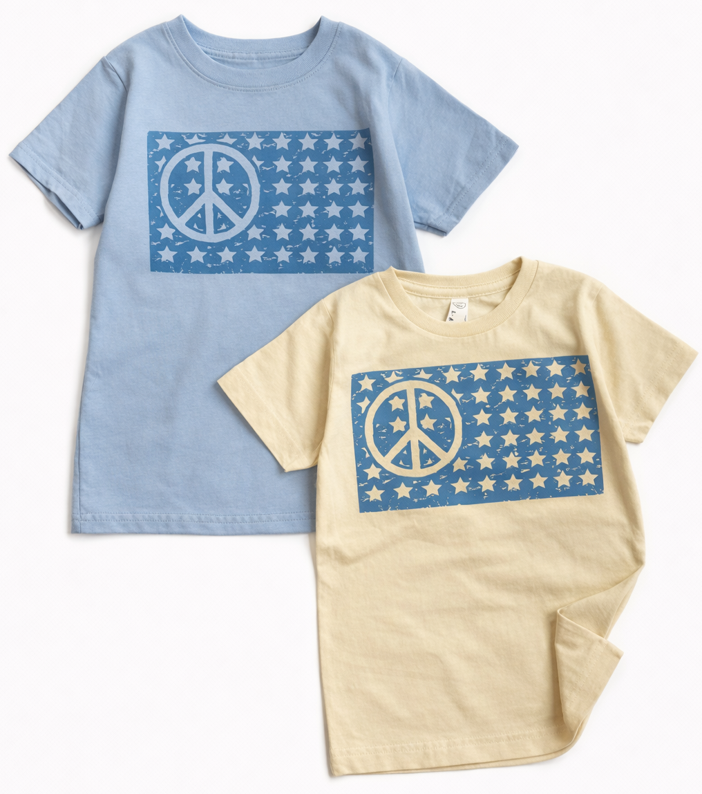 Kids graphic T-shirt featuring an American peace flag design by The Wishing Elephant, perfect for 4th of July celebrations.