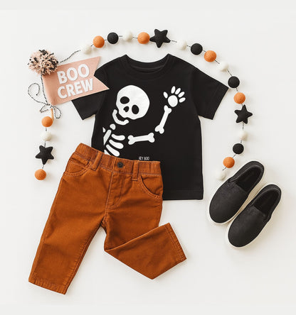 Children's Halloween outfit with black t-shirt, brown pants, and black shoes on a white background.