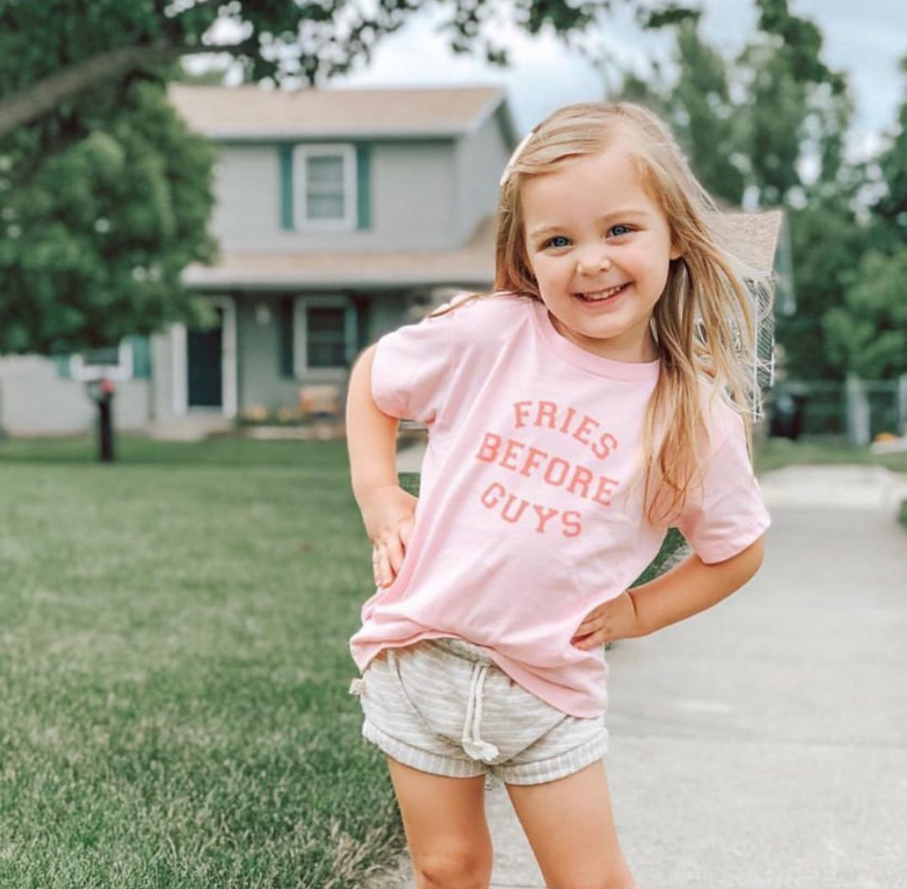 Fries Before Guys shirt flat lay with pink background

Funny retro t-shirt for toddlers – fries before guys design

Girl wearing Fries Before Guys tee in backyard

Sassy pink kids’ shirt with retro camp vibes