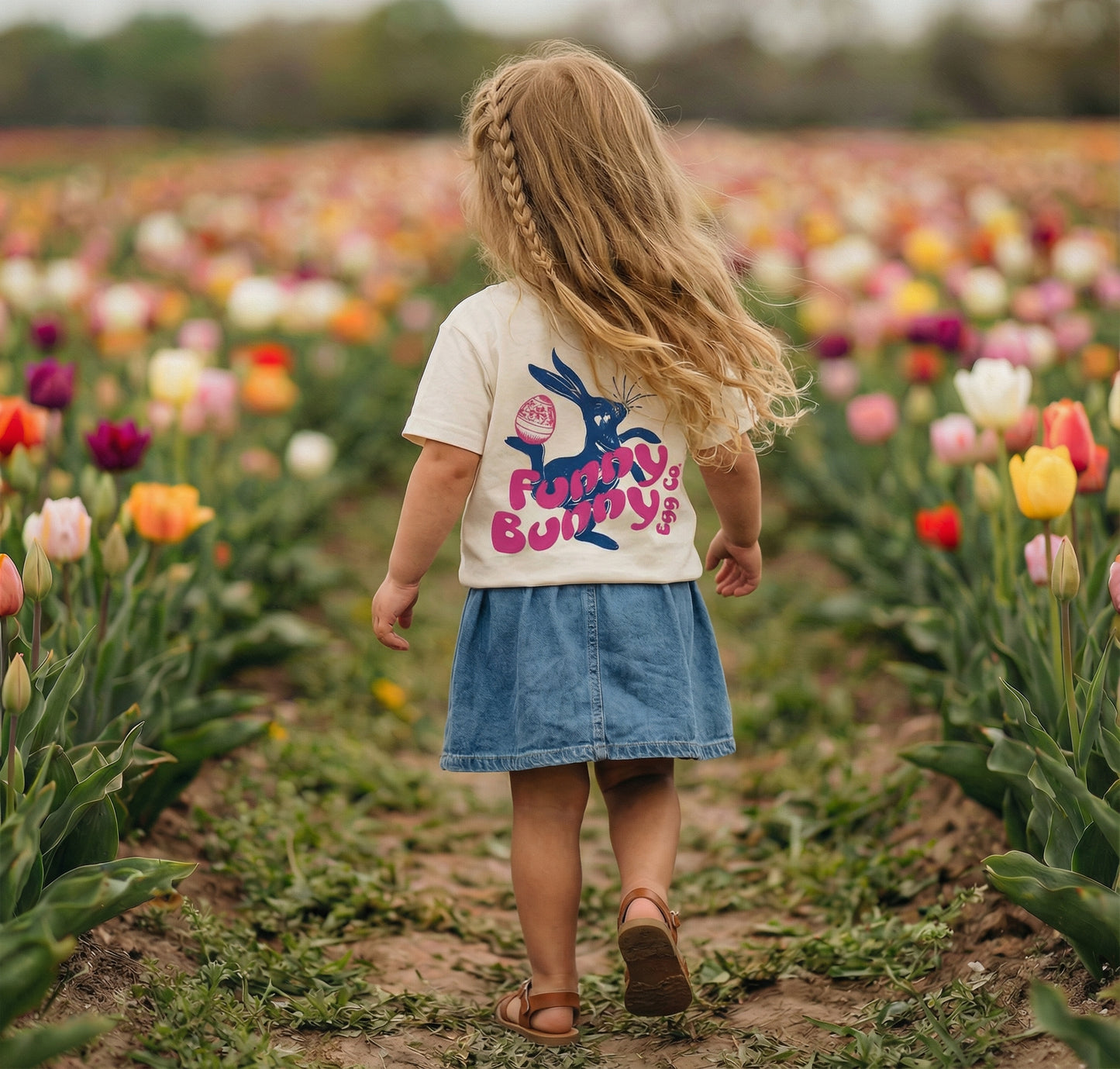 Back view of a Funny Bunny Egg Co T-shirt by The Wishing Elephant, featuring playful bunny and egg graphic on a casual tee.