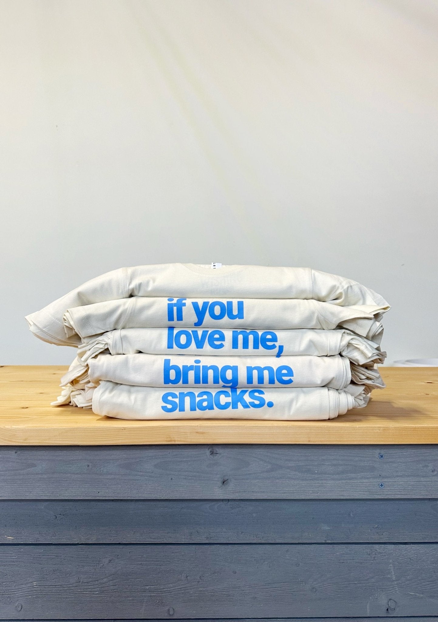 Kids and adults' graphic t-shirt by The Wishing Elephant with "If you love me, bring me snacks" design. Comfortable casual tee.