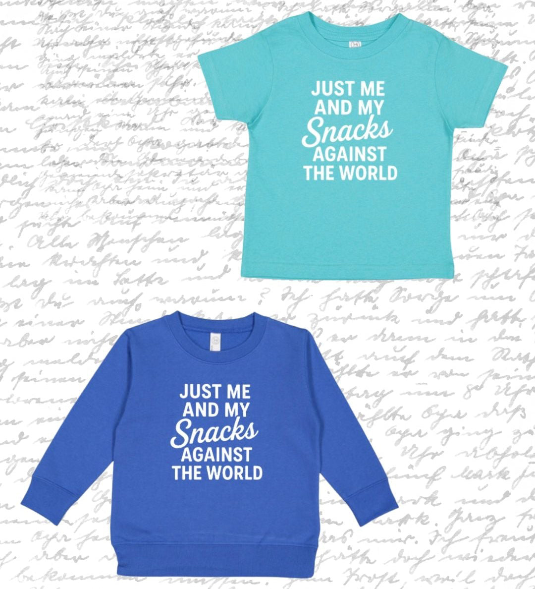 Two kids' graphic t-shirts displayed against a white background with faint cursive writing. The top shirt is light aqua blue with white text reading 'JUST ME AND MY Snacks AGAINST THE WORLD'.