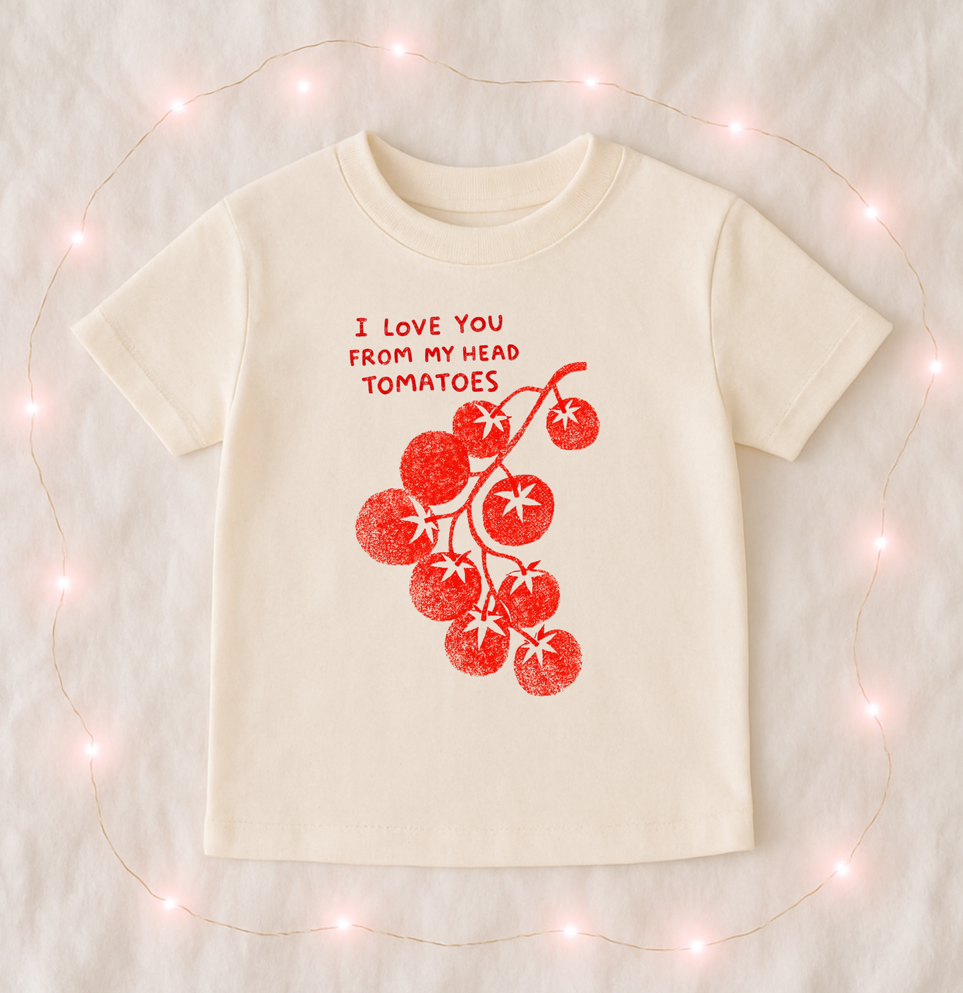 The Wishing Elephant love you from my head tomatoes T-shirt with a playful tomato graphic on a natural-colored background.