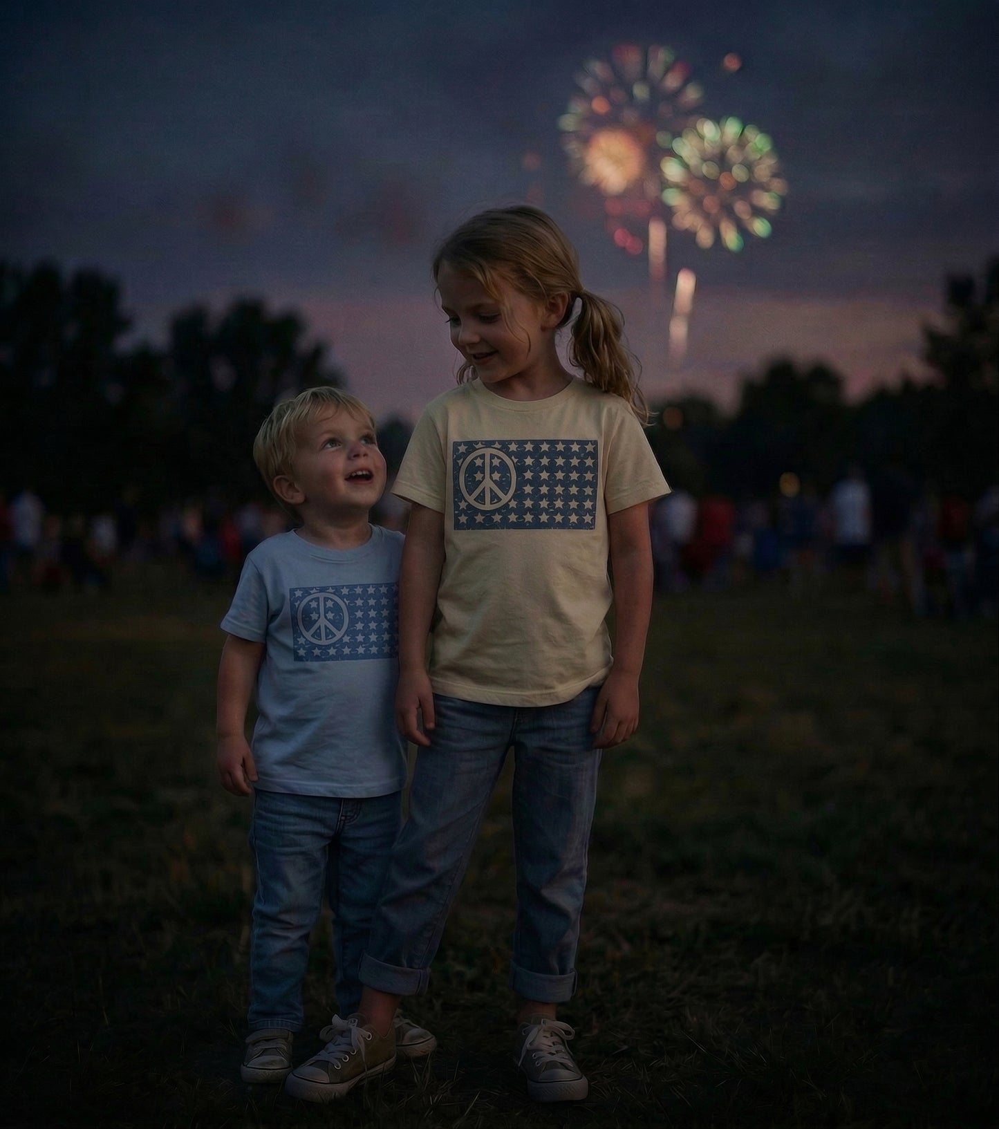 Kids wearing American peace flag graphic T-shirts by The Wishing Elephant, featuring a brother and sister celebrating 4th of July.