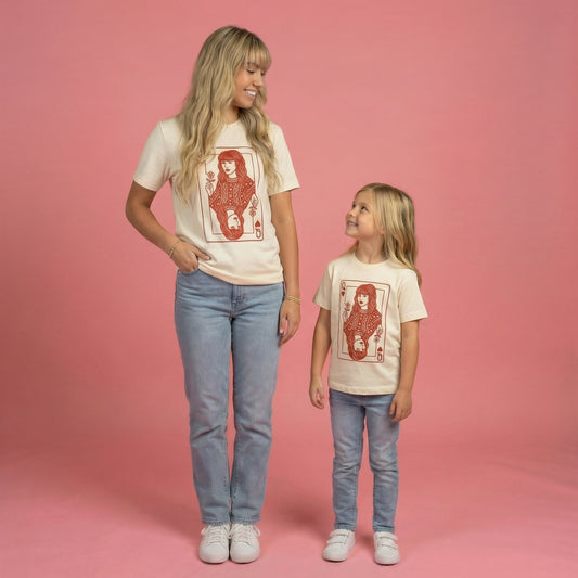 Woman and child wearing matching t-shirts with a graphic design on a pink background Taylor queen of hearts