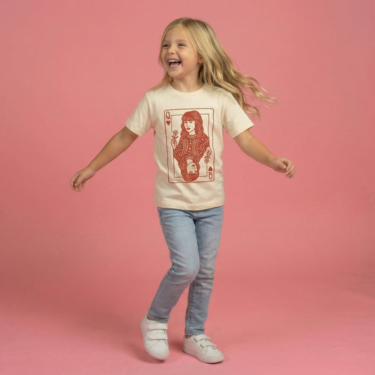 Child wearing a t-shirt with a graphic design on a pink background Taylor queen of hearts valentine shirt