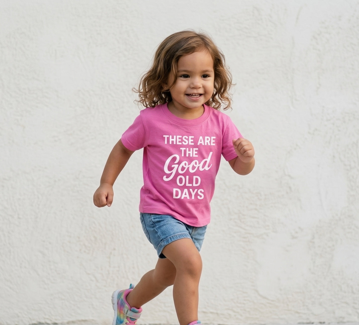 Pink kids graphic tee by The Wishing Elephant with the phrase "These Are The Good Old Days" printed on the front.